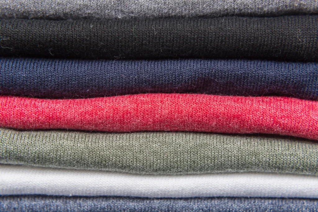 Stack of neatly folded t-shirts in different colors